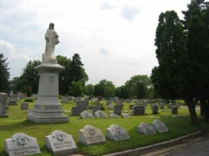 Colonial Memorial park cemetery with prominent memorial statue in foreground