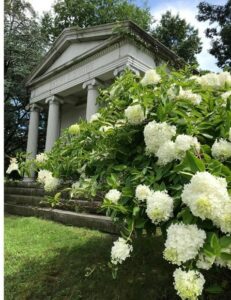 mausoleum at harleigh cemetery with white hydrangea flowers