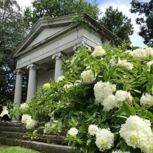 mausoleum at harleigh cemetery with white hydrangea flowers